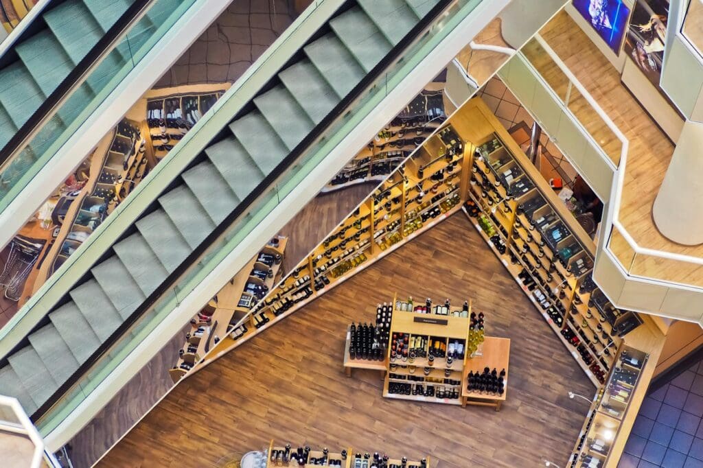 Aerial view of a stylish shopping mall showcasing escalators and well-organized retail displays.